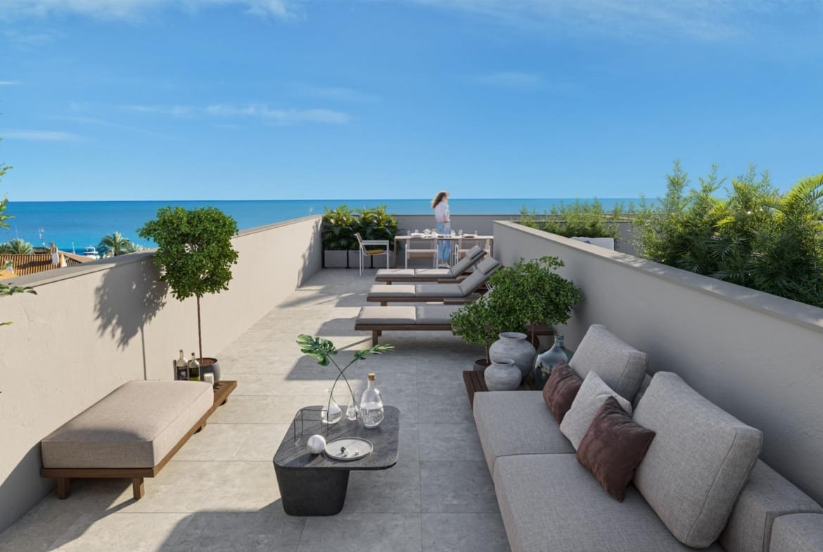 Rooftop solarium with a sofa, sun loungers, dining furniture and sea views in Los Narejos, Murcia