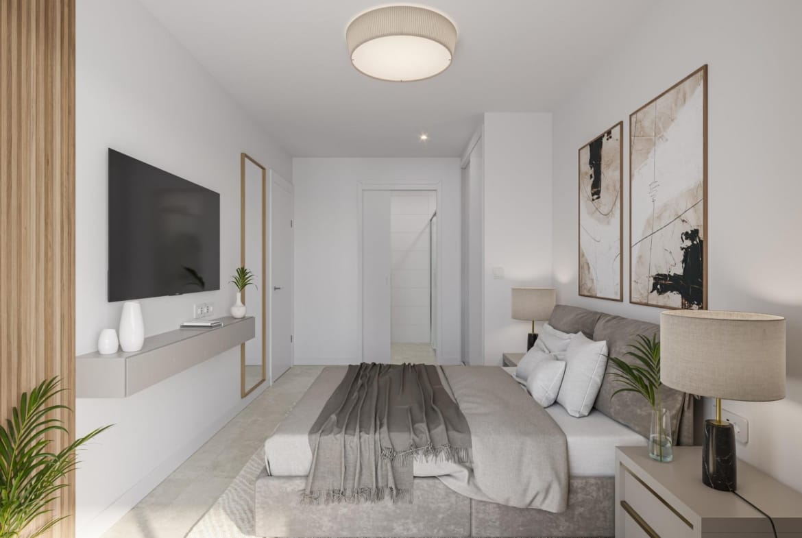 Bedroom with an upholstered bed, built-in wardrobe and wall-mounted television in Los Narejos, Murcia