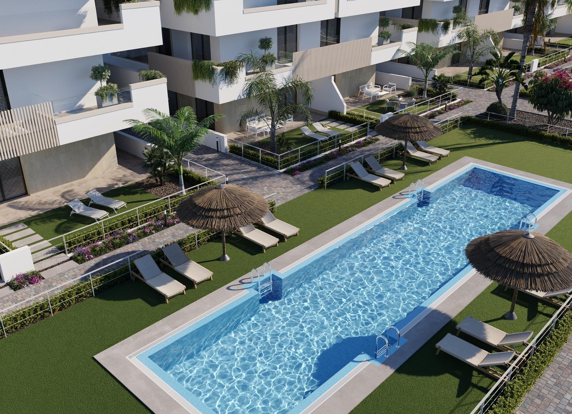New-Build-Apartments-and-Bungalows-in-Santa-Rosalia-Lake-and-Life-Resort-1 Long communal swimming pool with sun loungers and private ground-floor terraces nearby