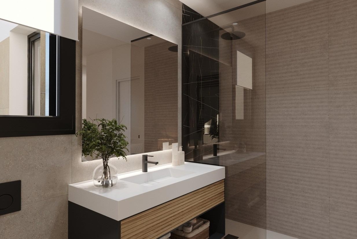 Vanity unit with integrated sink, large mirror and adjacent glass shower enclosure