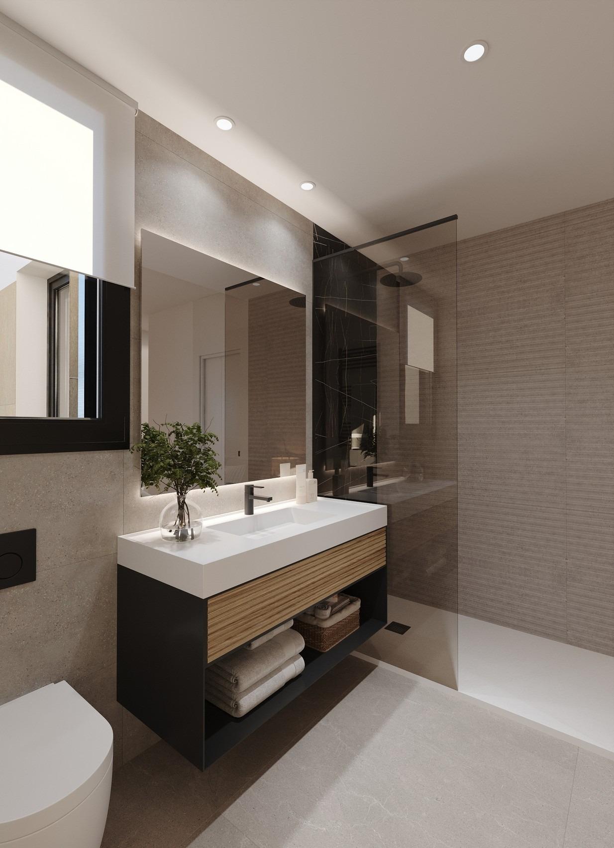 Vanity unit with integrated sink, large mirror and adjacent glass shower enclosure