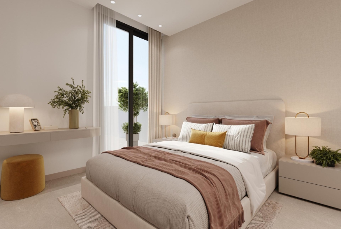 Neutral-toned bedroom with balcony doors, bedside tables and decorative plants