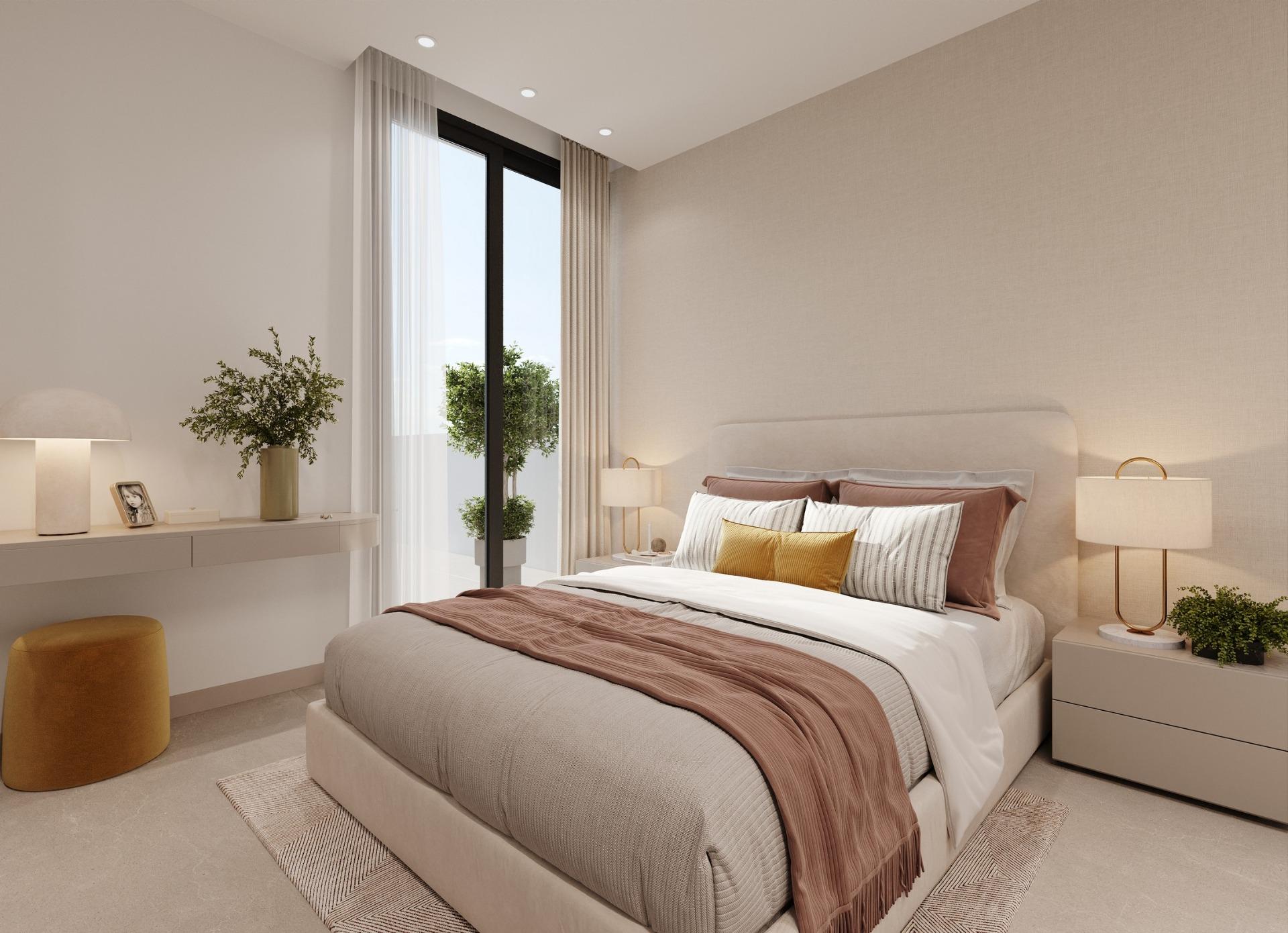 Neutral-toned bedroom with balcony doors, bedside tables and decorative plants