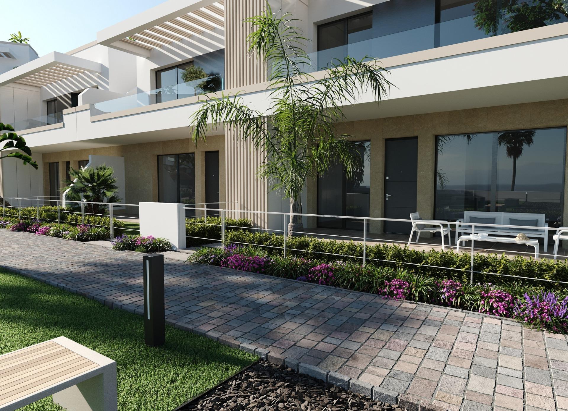 Ground-floor terraces and modern building facade with glass balcony fronts and plantings