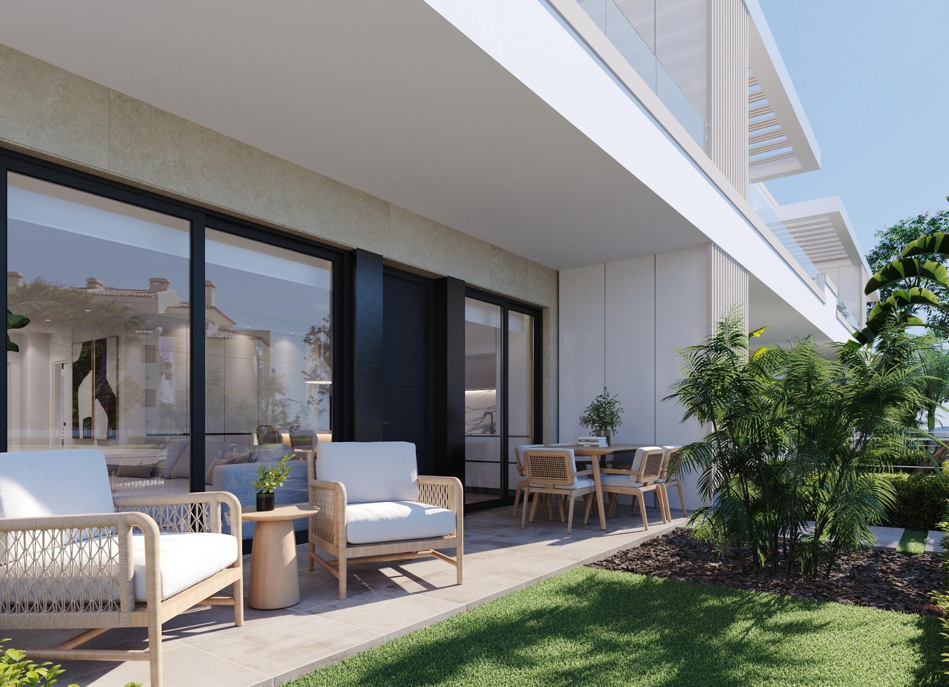 Ground-floor terrace with cushioned wicker seats, dining table and sliding glass doors to interior