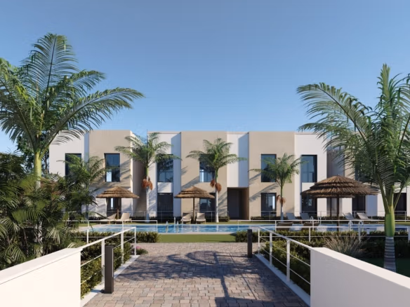 Modern low-rise apartments with central swimming pool, sunbeds and palm trees in foreground