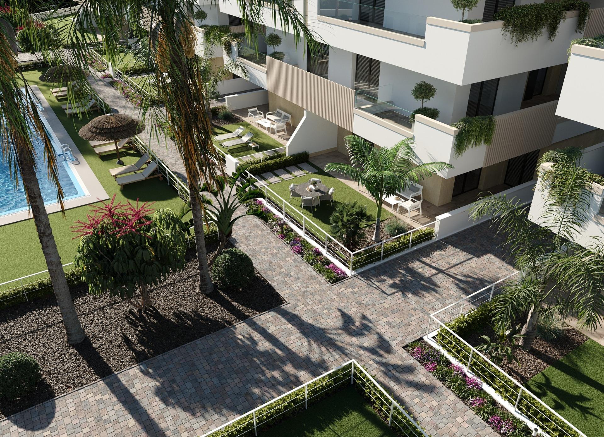 New-Build-Apartments-and-Bungalows-in-Santa-Rosalia-Lake-and-Life-Resort-2 Ground-floor terraces with garden seating, palm trees and paved pedestrian paths
