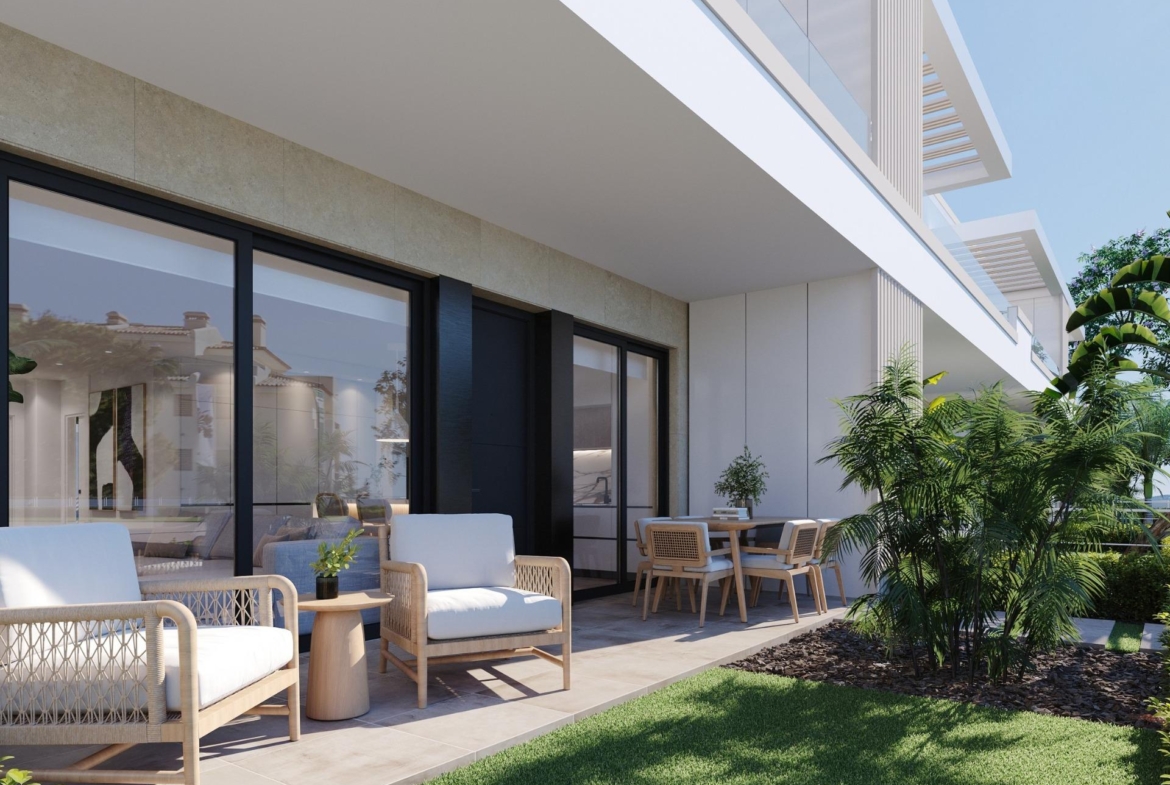 Shaded ground-floor terrace with sofa seating, dining table and decorative planting nearby