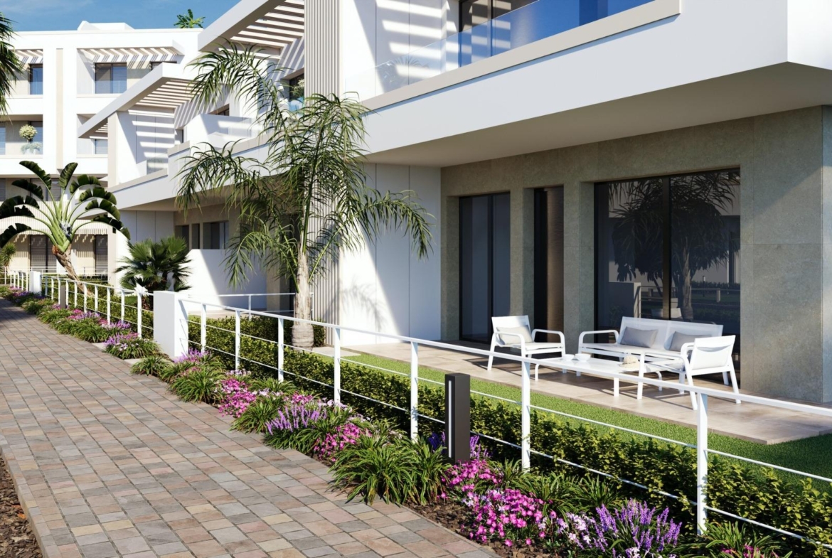 Ground-floor terrace with outdoor seating beside a landscaped paved walkway