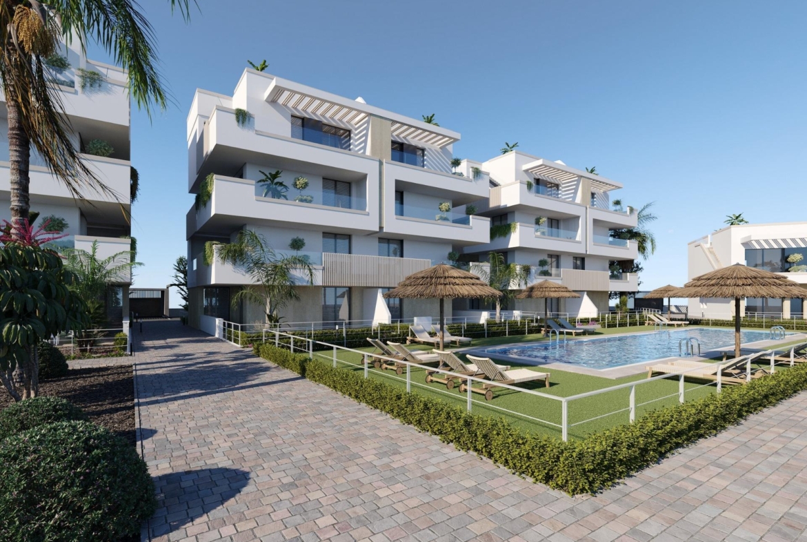 Three-storey residential block beside a pool, sun loungers and landscaped garden paths