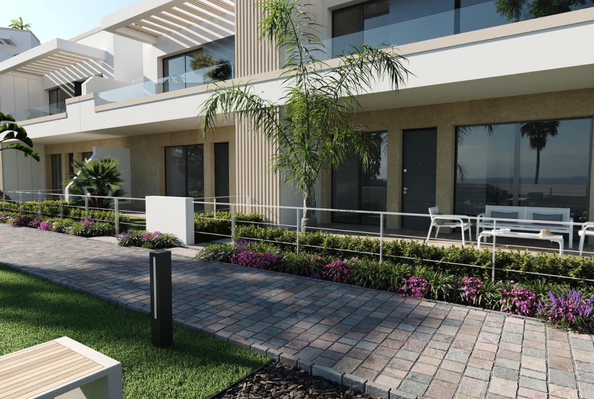 Paved walkway leading to ground-floor patio with outdoor seating and planted borders