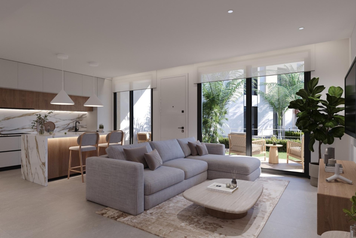 Open-plan living room looking towards a kitchen island, sliding doors and terrace beyond