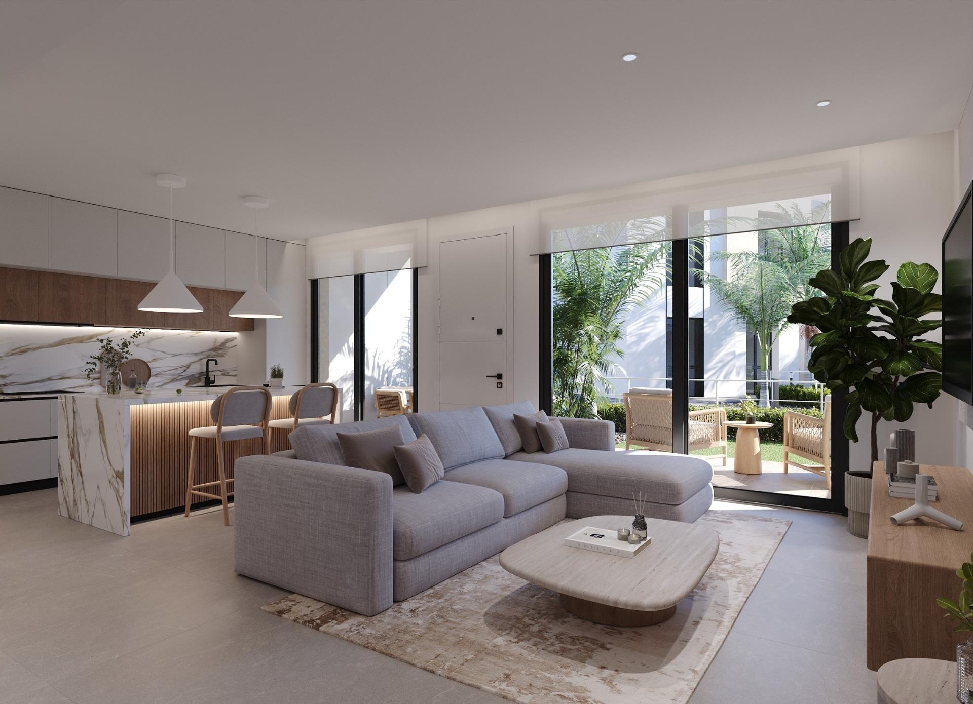 Open-plan living room looking towards a kitchen island, sliding doors and terrace beyond