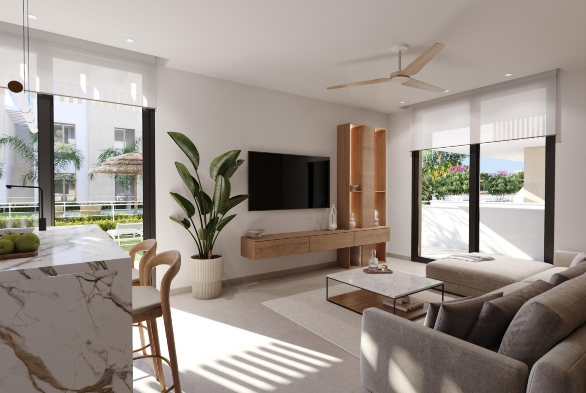 Open-plan living room with TV wall, kitchen island and terrace doors