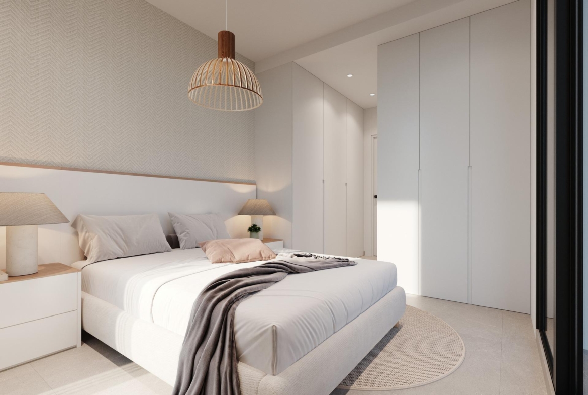 Neutral master bedroom with bed, bedside tables and floor-to-ceiling wardrobes