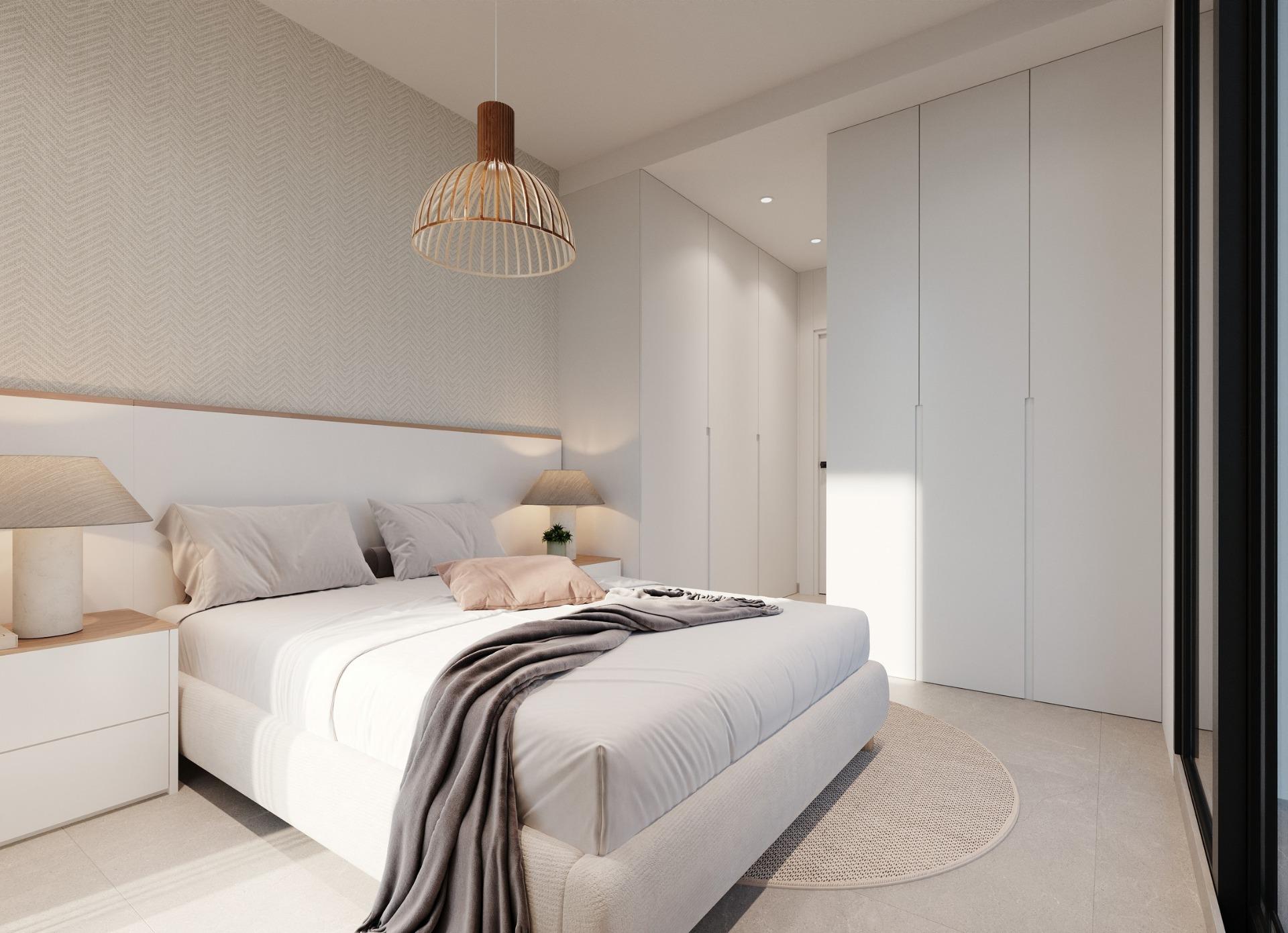 New-Build-Apartments-and-Bungalows-in-Santa-Rosalia-Lake-and-Life-Resort-7 Neutral master bedroom with bed, bedside tables and floor-to-ceiling wardrobes
