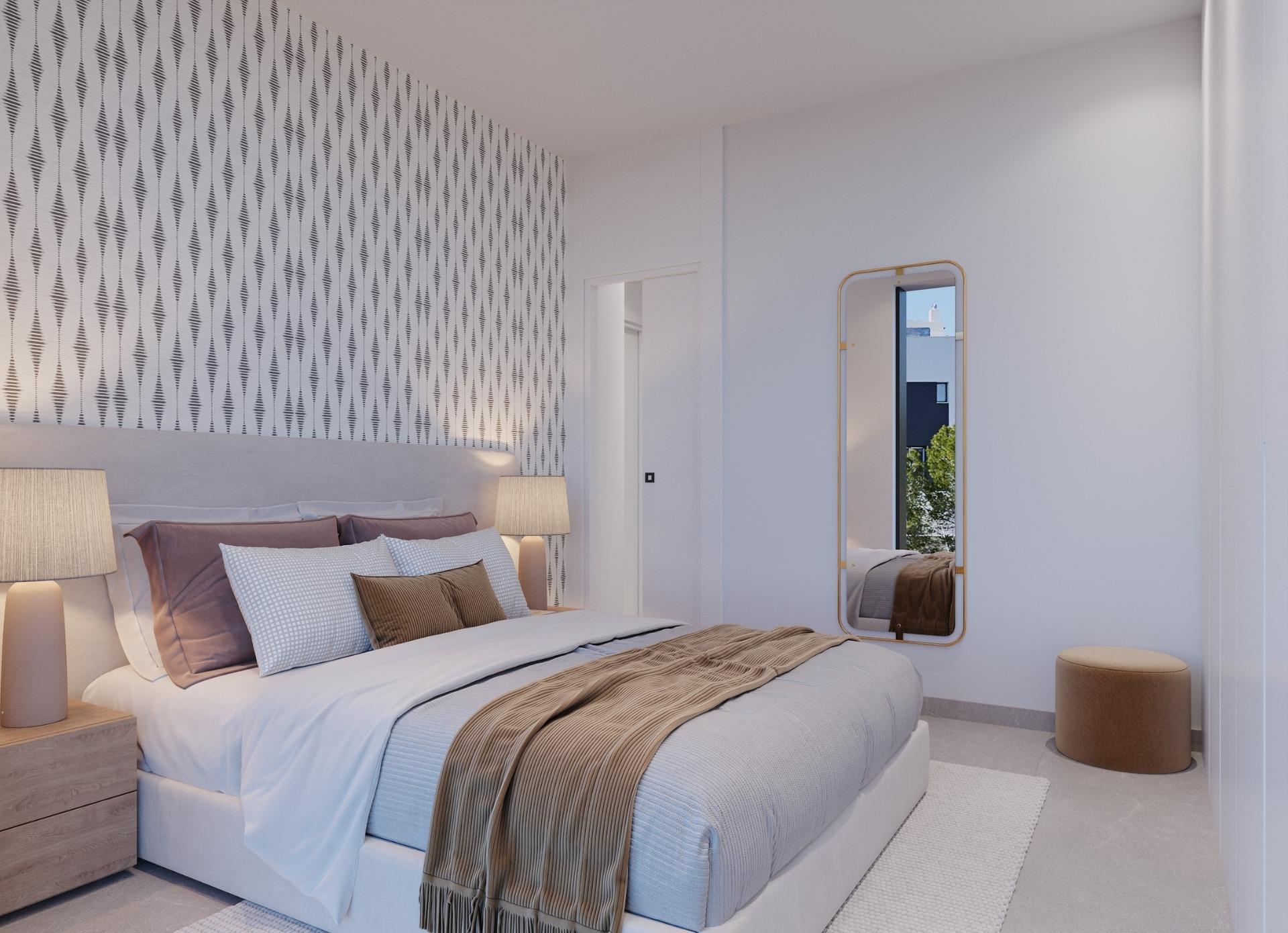 Double bedroom with patterned accent wall, bedside lamps and full-length mirror