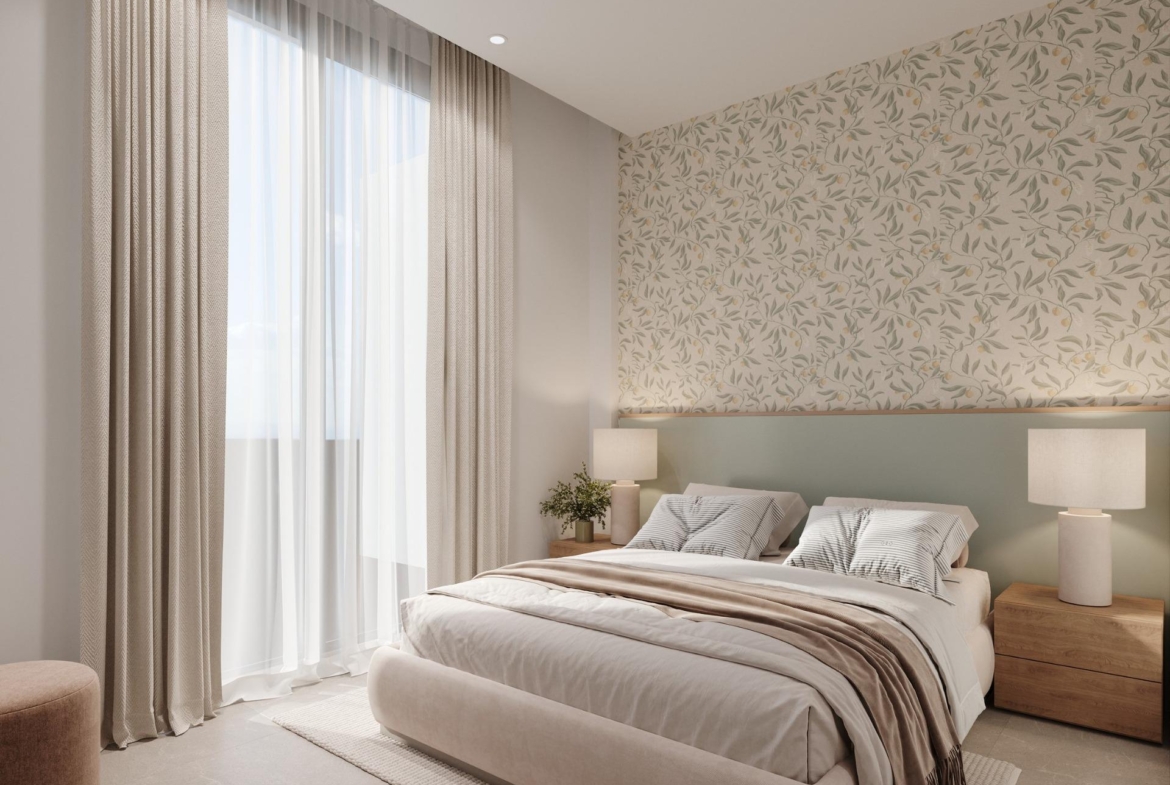 Double bedroom with leafy-pattern feature wall and floor-to-ceiling curtains