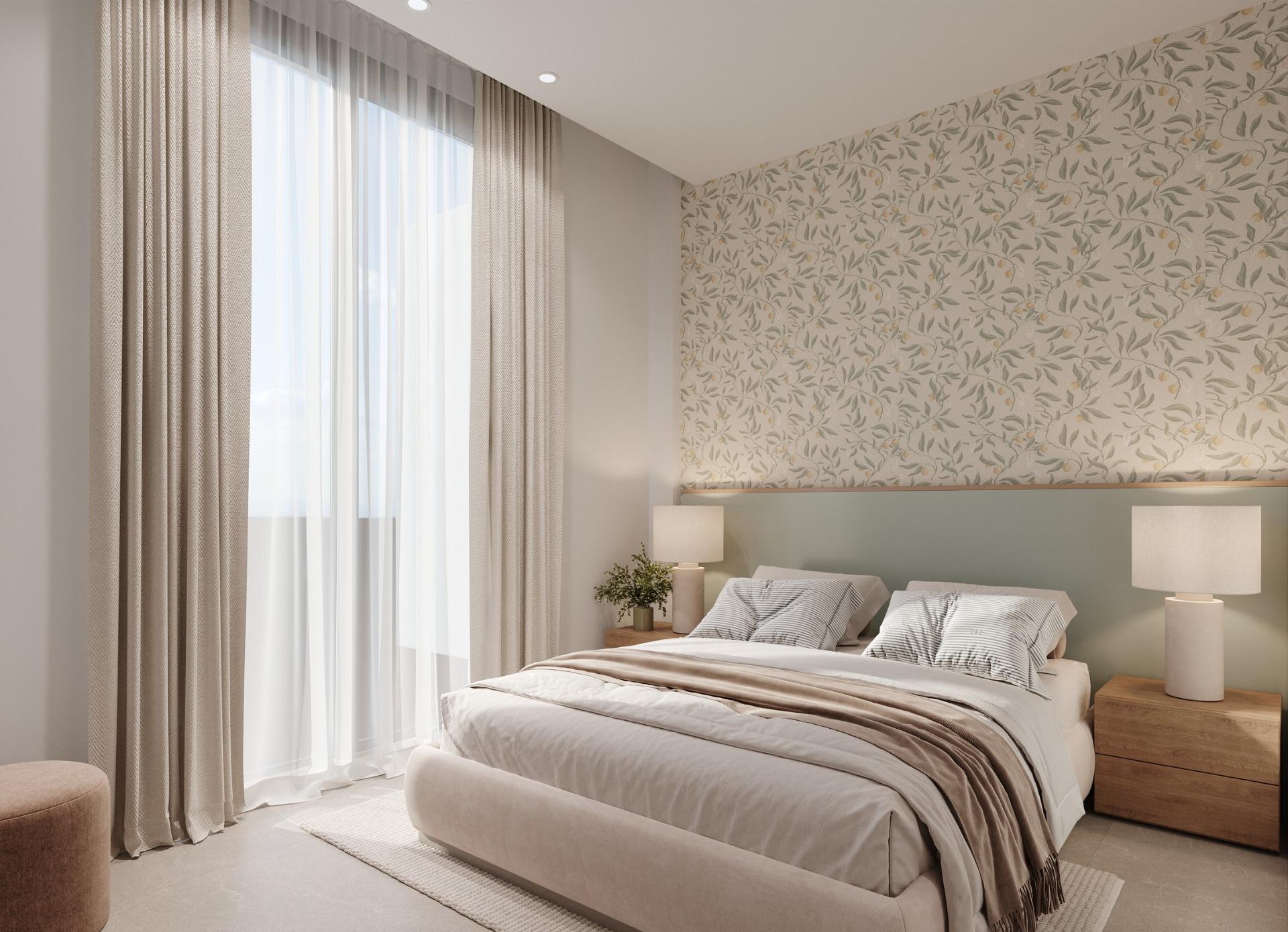 Bedroom with patterned floral feature wall, bedside lamps and sheer floor-to-ceiling curtains