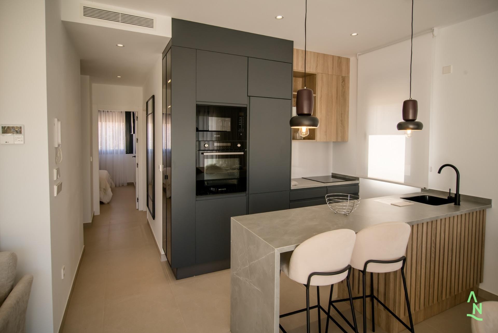 Modern kitchen with breakfast bar and integrated appliances