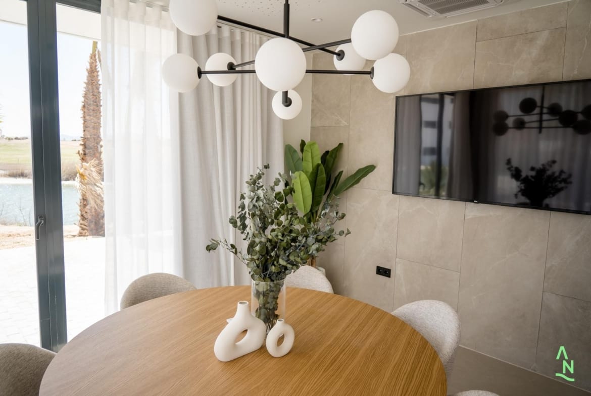 Dining corner with large window and wall-mounted television
