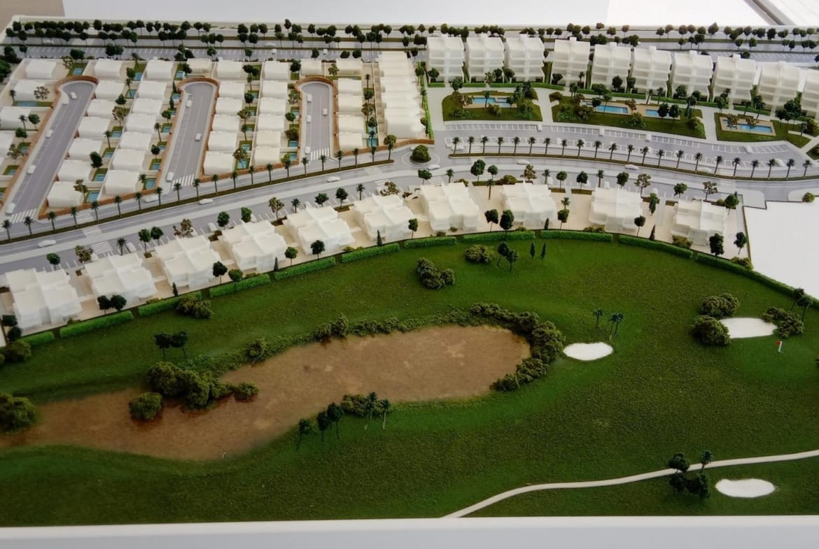 Scale site model showing homes beside the golf course