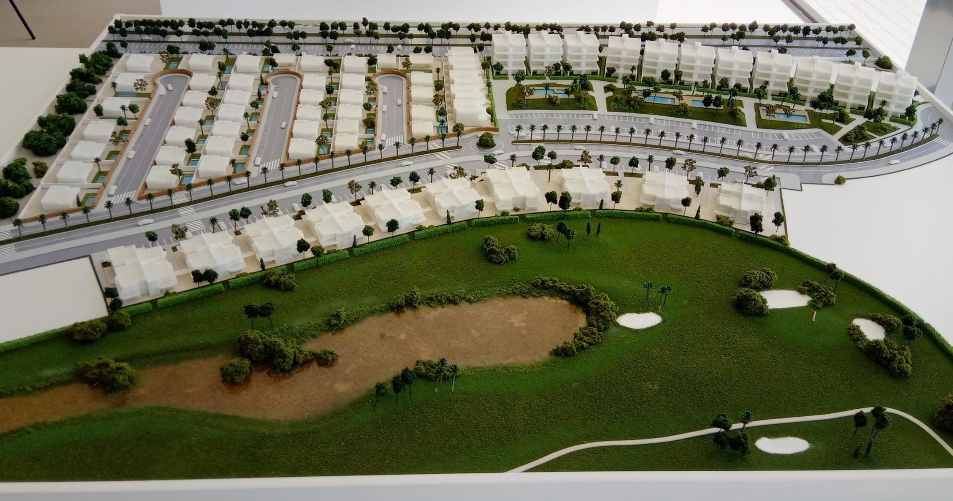 Scale site model showing homes beside the golf course