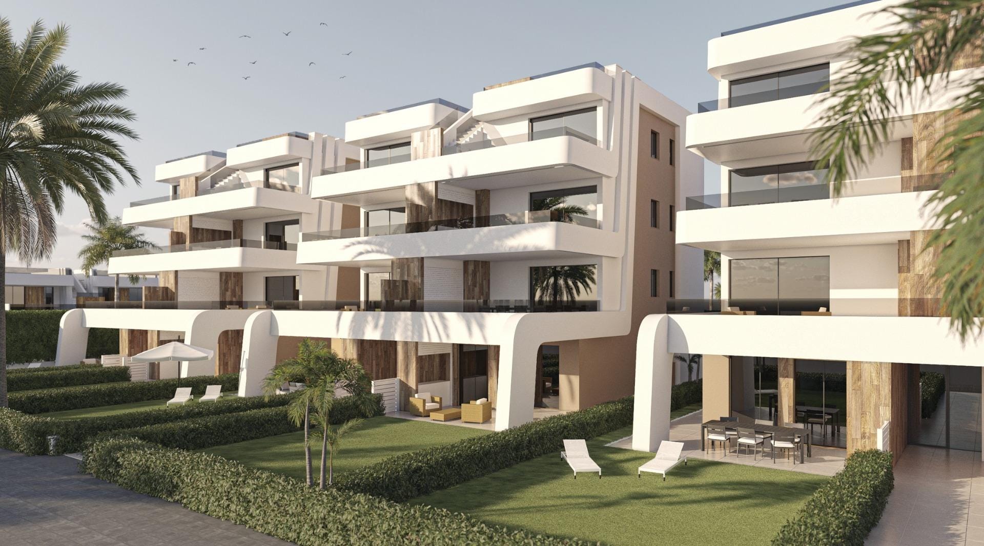 Modern apartment facade with ground-floor terraces and upper-level balconies
