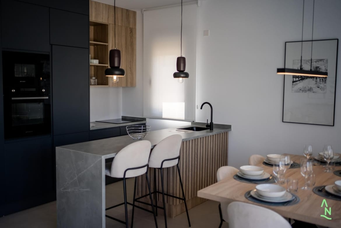 Modern penthouse kitchen with breakfast bar and dining area