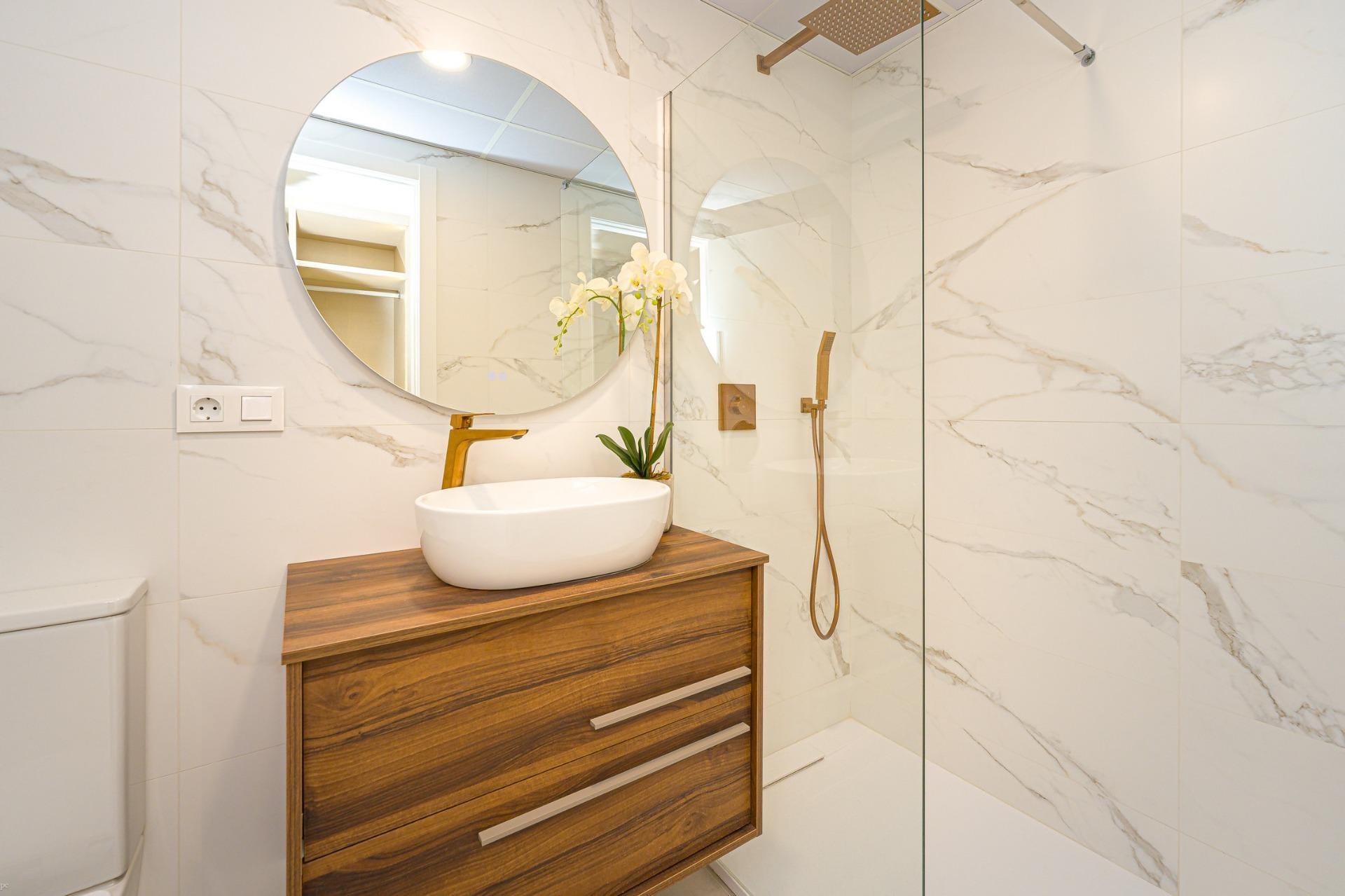 Stylish bathroom with marble-look tiles, wooden vanity and walk-in shower