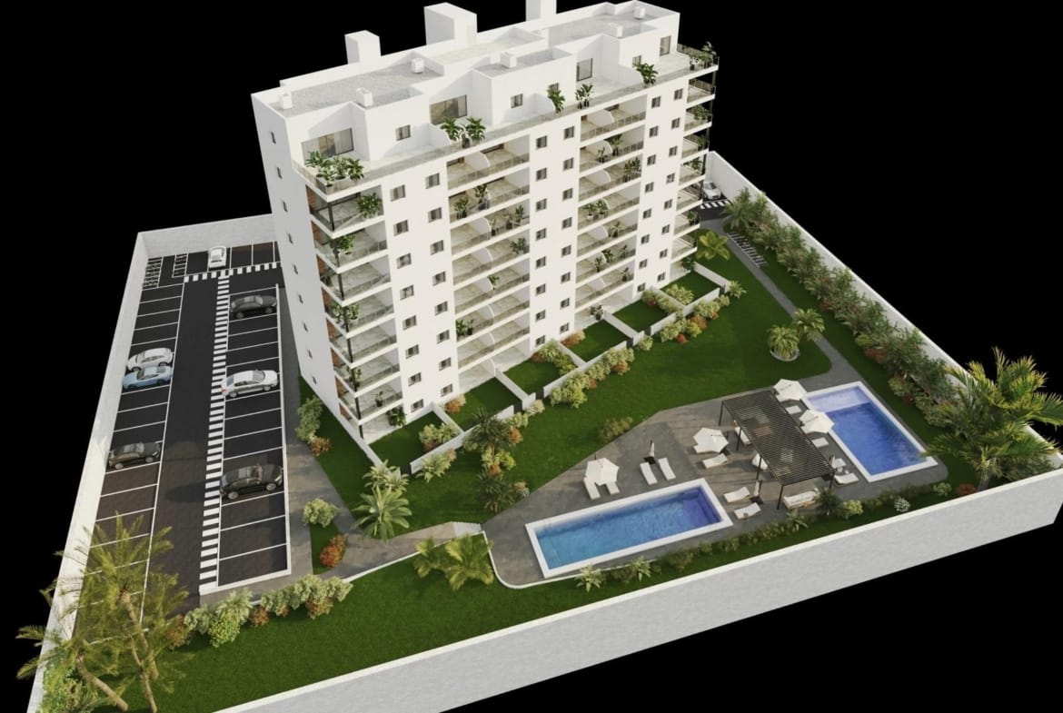 Aerial view of the apartment building with landscaped grounds, parking and two communal pools
