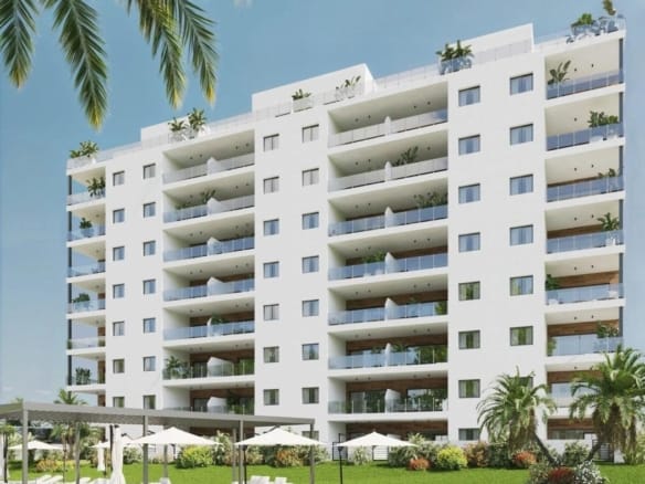 Modern apartment building with landscaped gardens and a communal pool