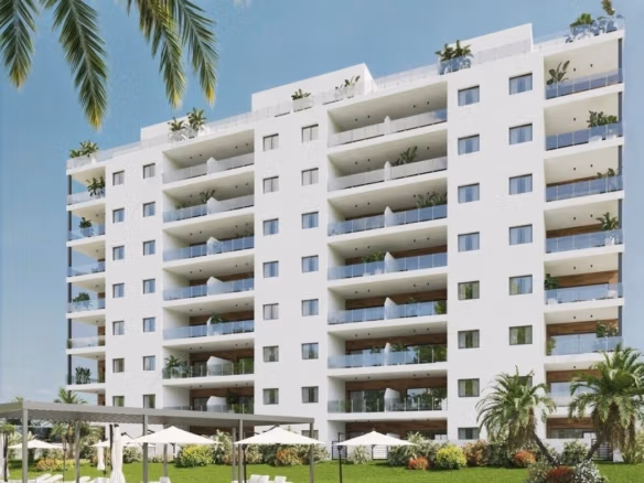 Modern apartment building with landscaped gardens and a communal pool