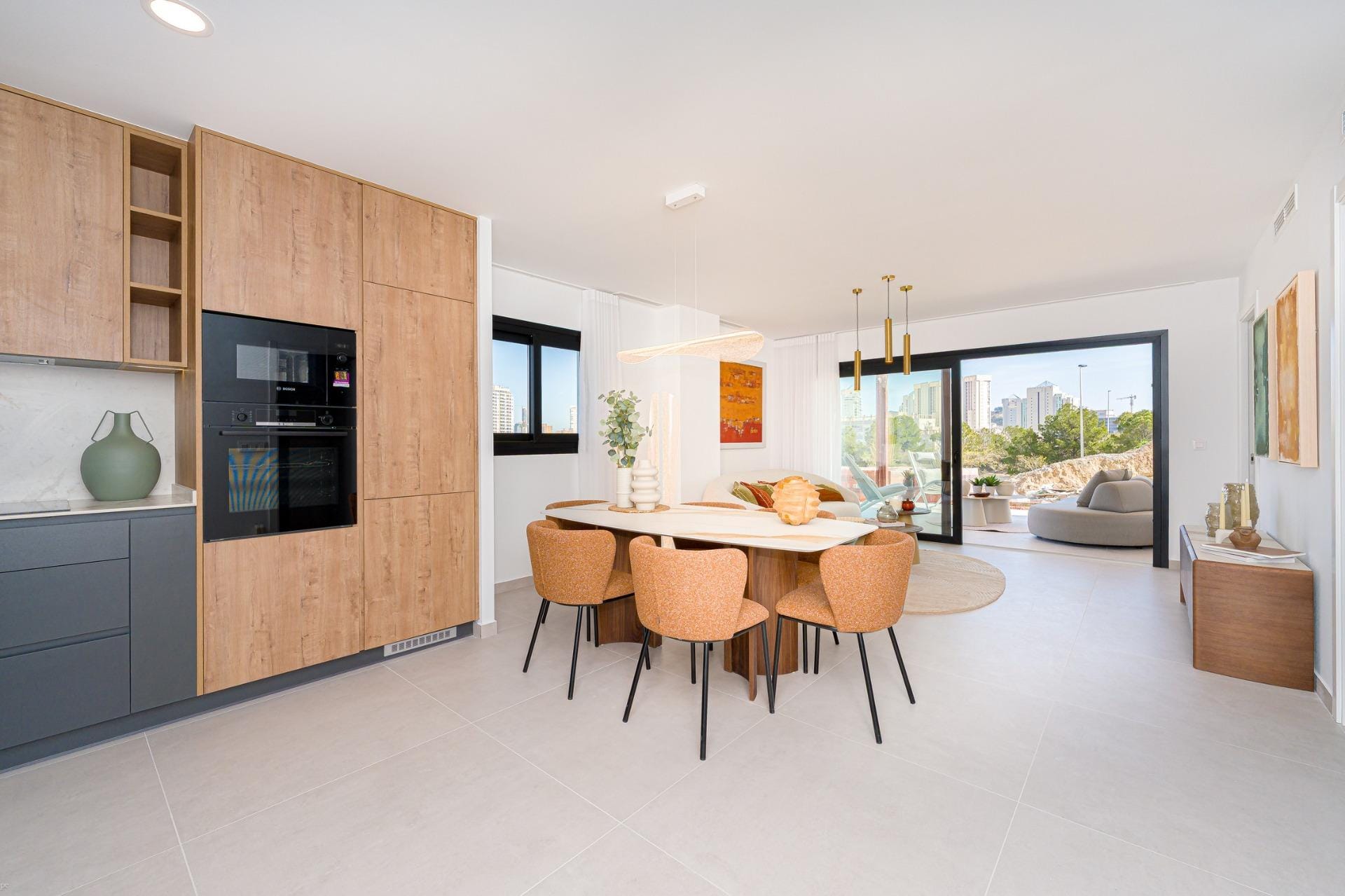 Open-plan living and dining room with kitchen and terrace access