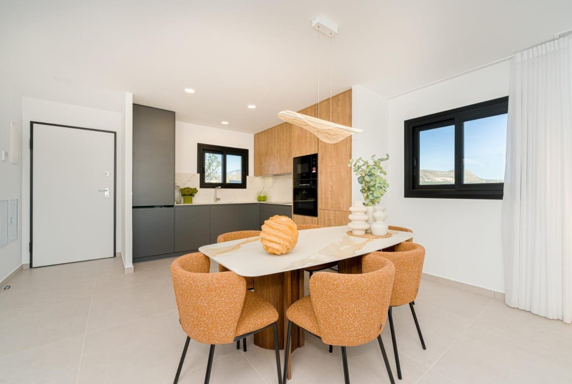 Open-plan dining area and modern kitchen with wood-effect cabinets