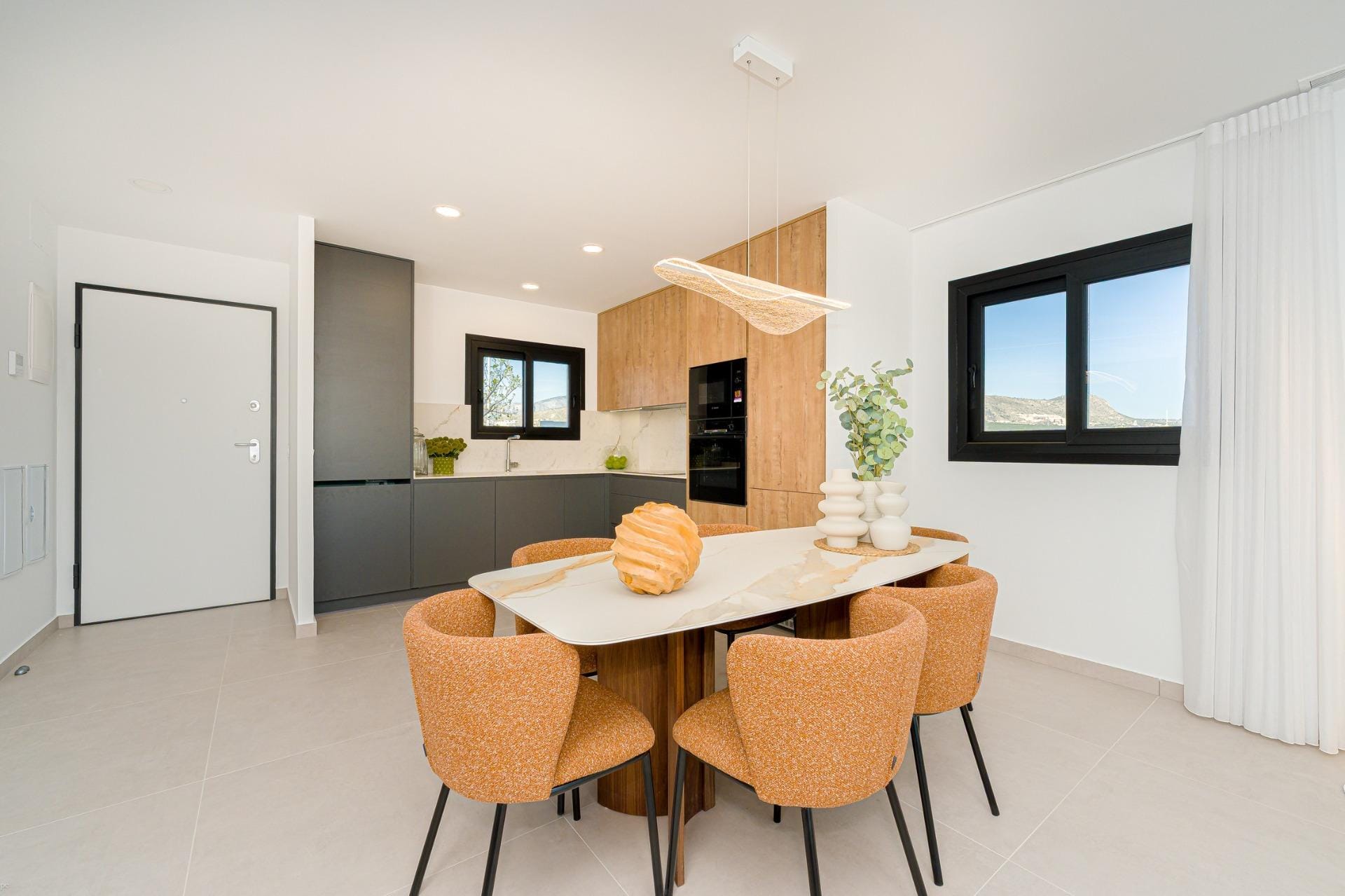Dining area beside a modern open-plan kitchen