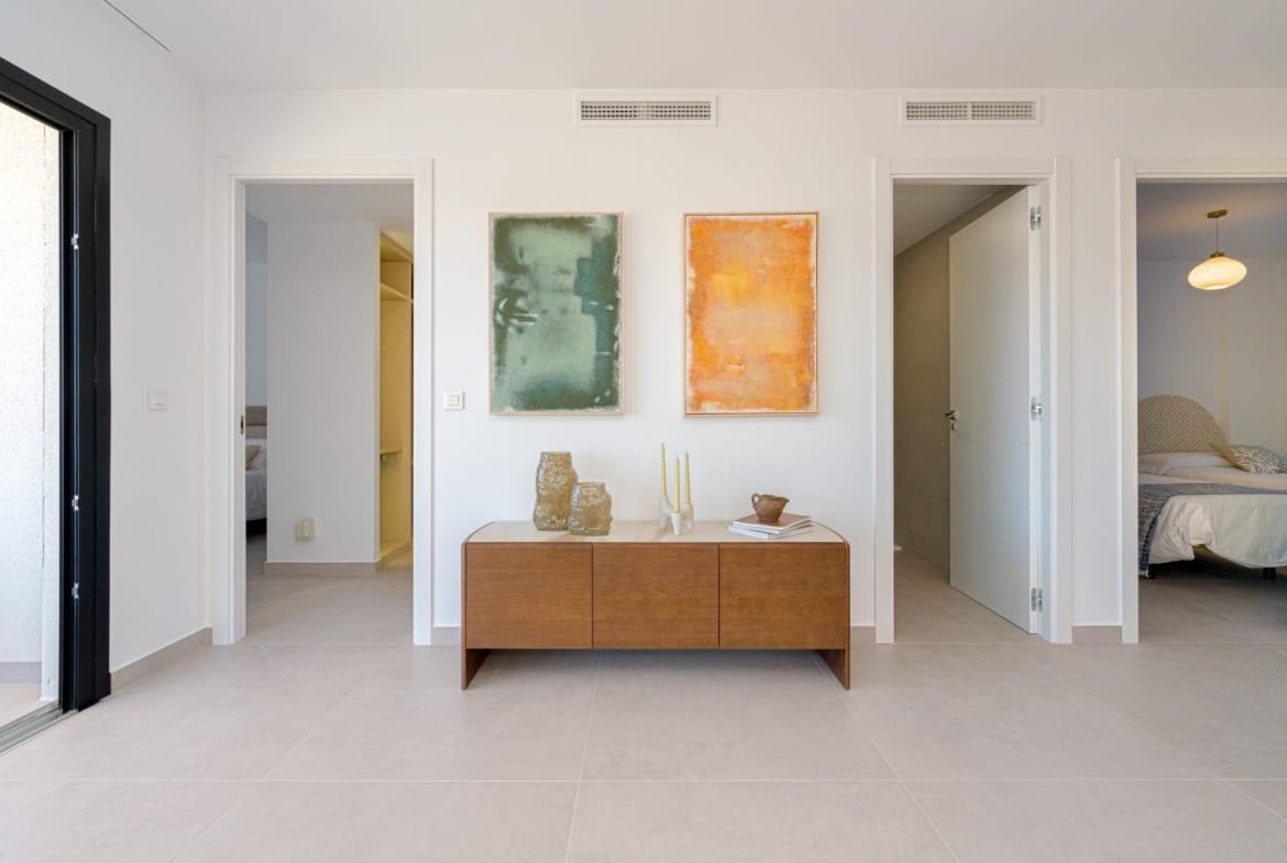Interior hallway with built-in storage and access to bedrooms and bathrooms