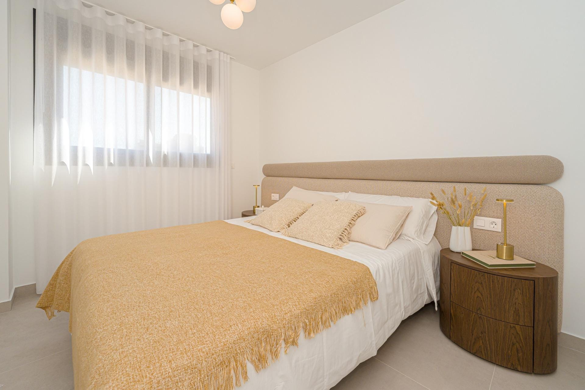Calm double bedroom with upholstered headboard and soft neutral decor