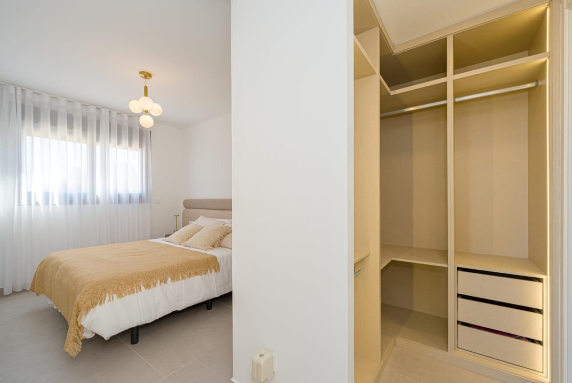 Bedroom with open dressing area and built-in storage