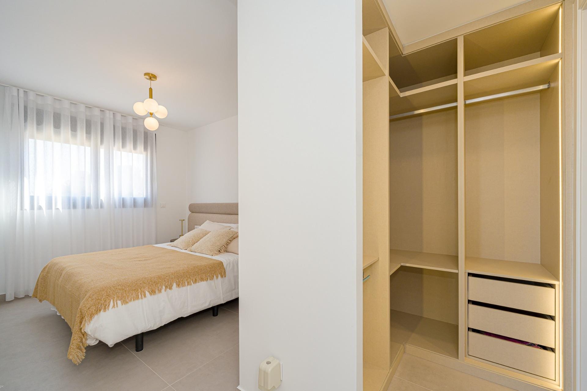 Bedroom with open dressing area and built-in storage