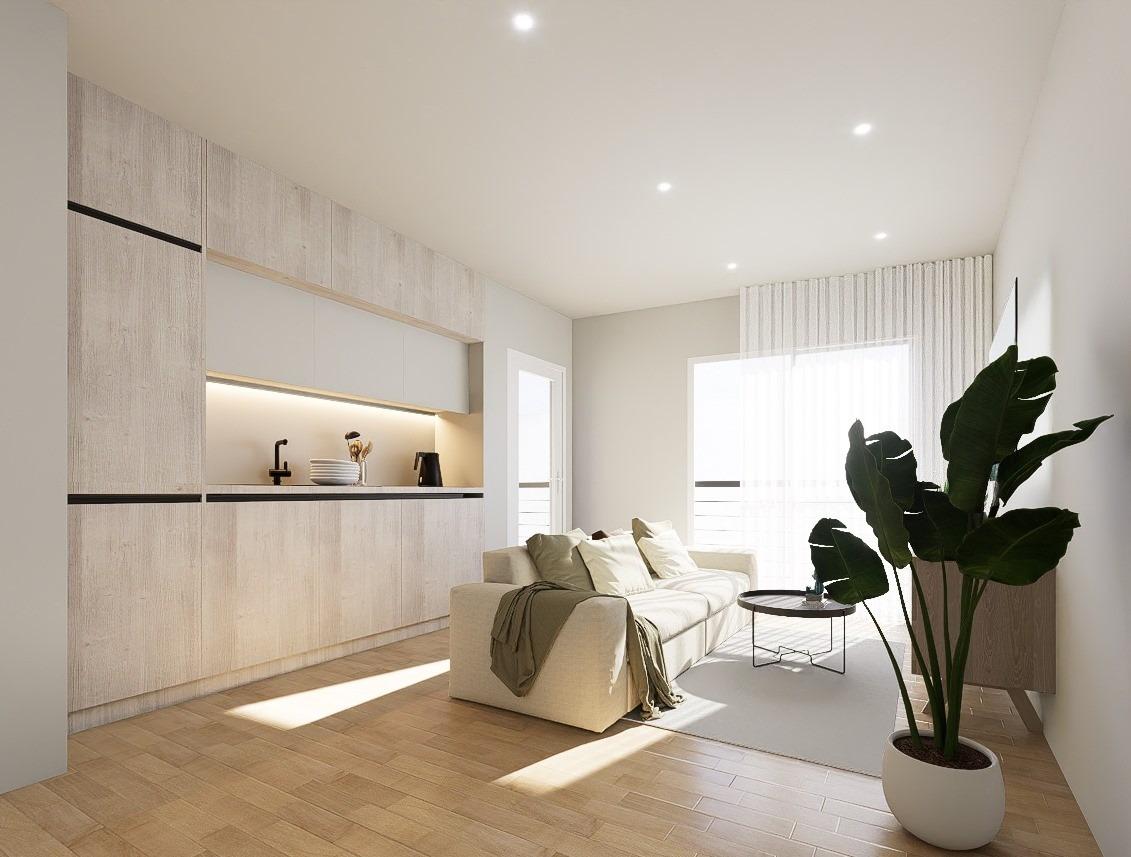 New-Build-Apartments-in-the-Centre-of-Torrevieja-Near-Playa-del-Cura-18 Open-plan kitchen and living area with light wood cabinets in a new build penthouse render
