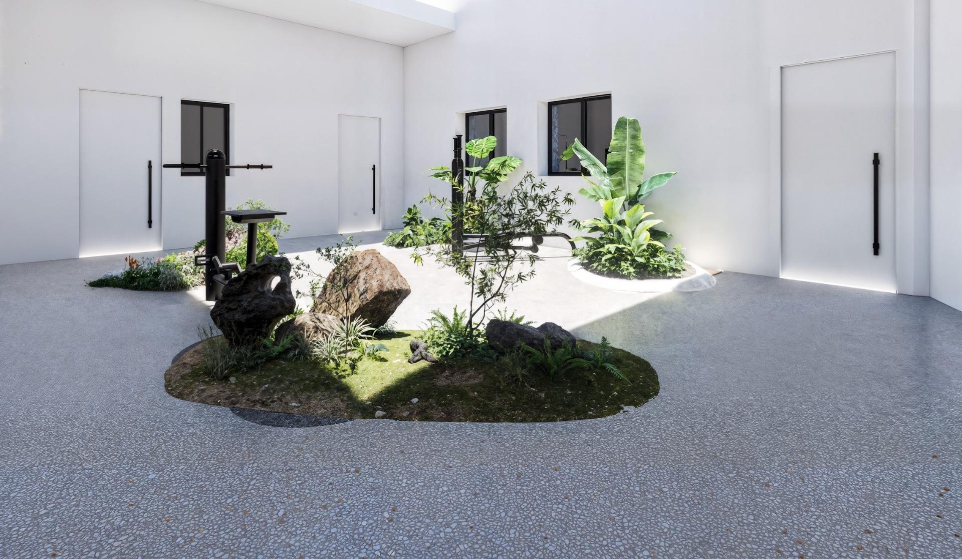 New-Build-Apartments-in-the-Centre-of-Torrevieja-Near-Playa-del-Cura-6 Sunlit interior courtyard with planted rock islands and black outdoor gym equipment.