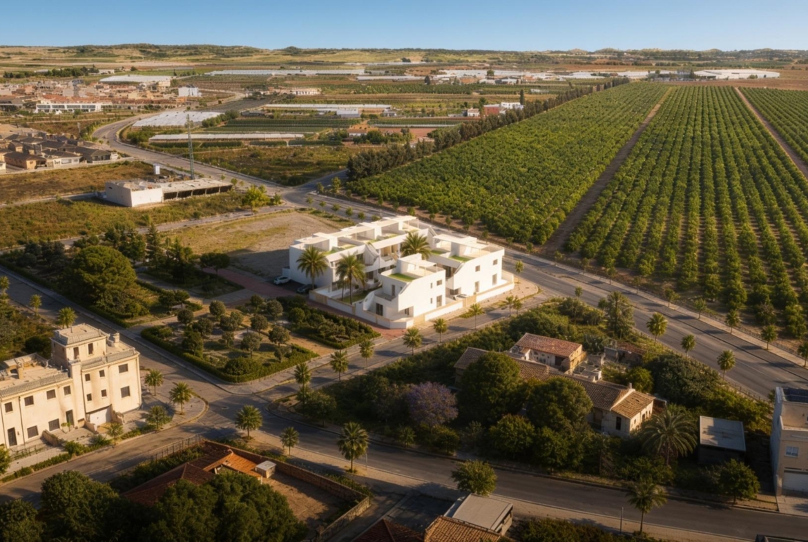 Aerial view showing the apartment cluster beside agricultural fields and surrounding roads