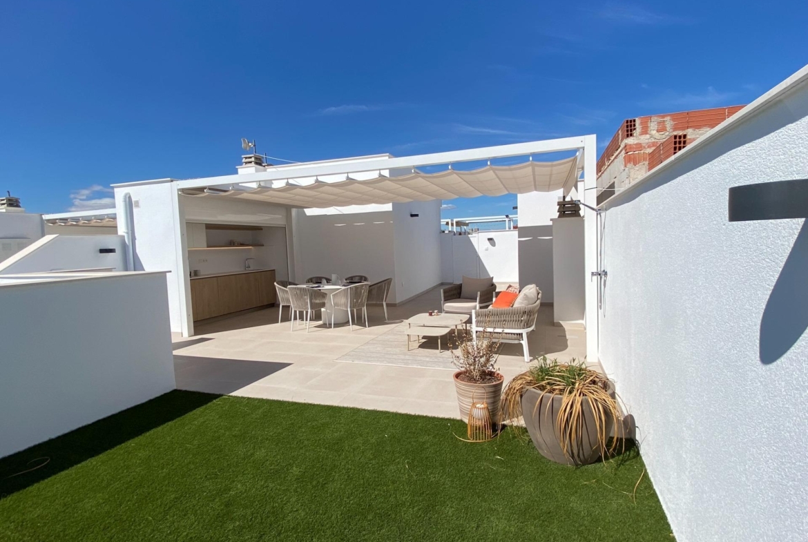 Rooftop terrace with pergola-covered seating area, outdoor kitchen and artificial grass section.