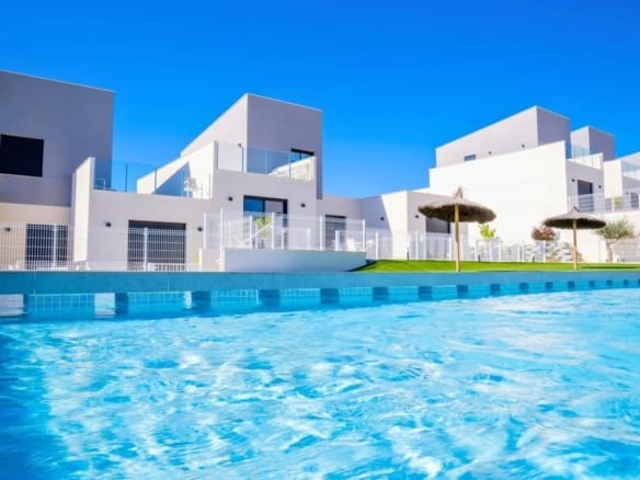 White homes beside a gravelled garden seating area and citrus tree in Altaona Golf, Baños y Mendigo, Murcia