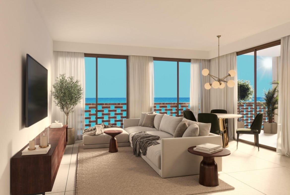 Bright living and dining area with large windows and sea views