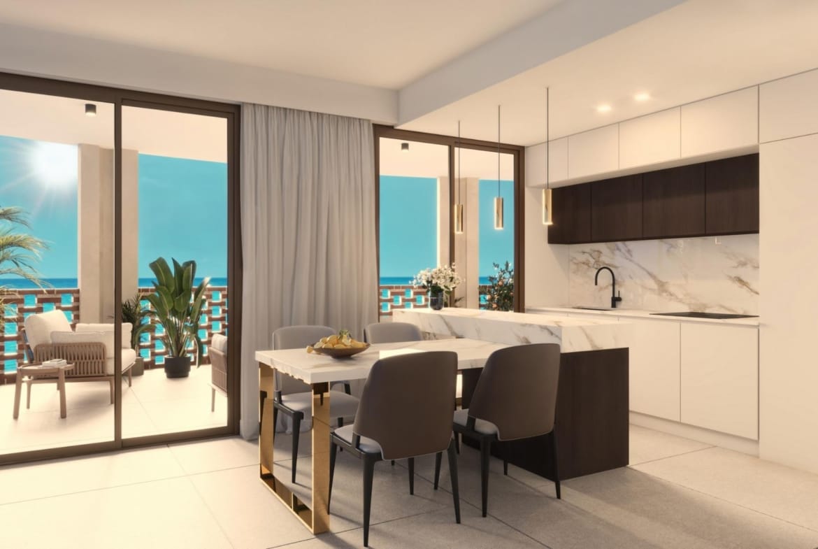 Open-plan kitchen and dining area with terrace access and sea views