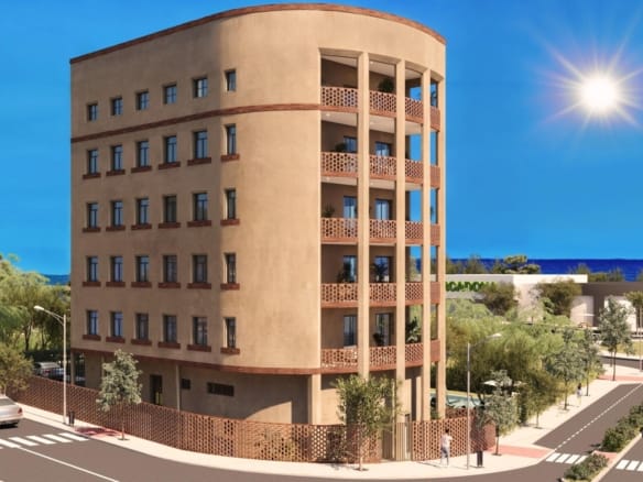 Street-facing exterior view of the apartment building with balconies near the coast