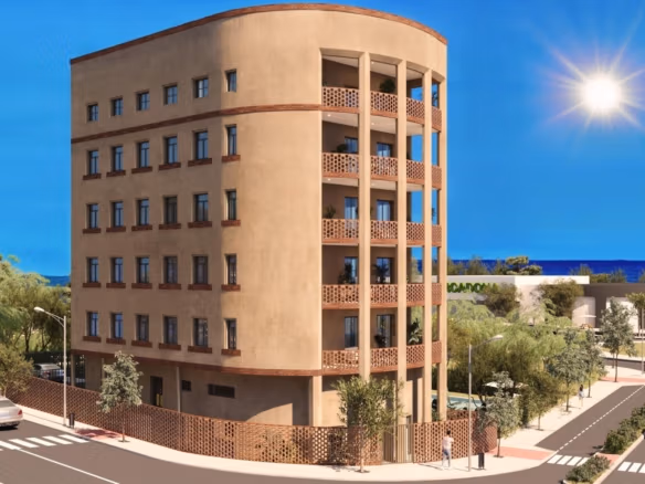Street-facing exterior view of the apartment building with balconies near the coast