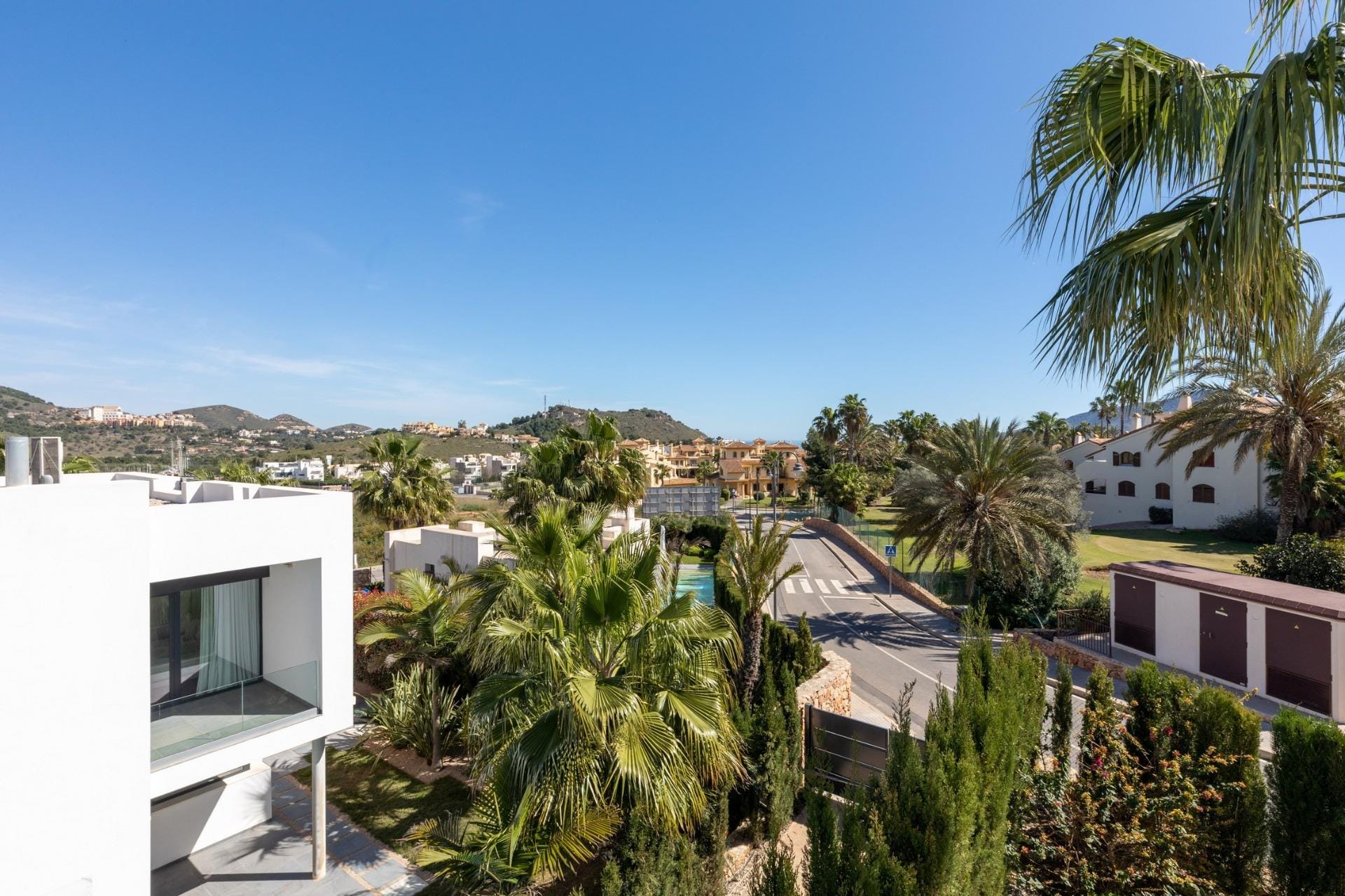 New-Build-Villas-for-Sale-at-La-Manga-Club-–-Luxury-Living-in-a-Prestigious-Resort-1 View over palm-lined surroundings and hills from the villa in La Manga Club, Murcia